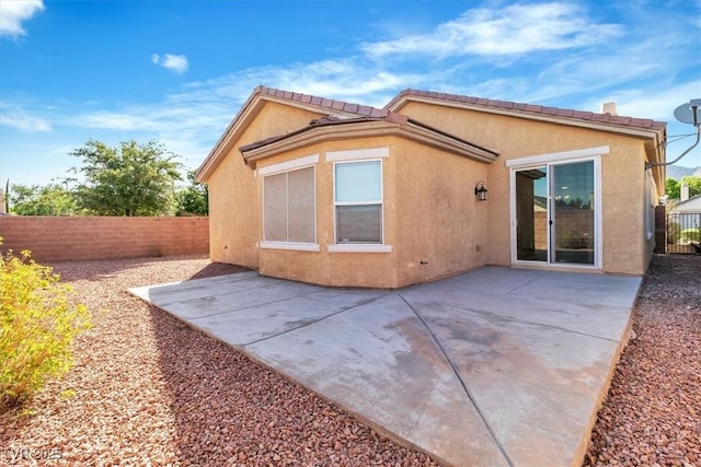 11253 Revelry Ln, Las Vegas, NV 89138 - back of house with a fenced backyard, stucco siding, and a patio area