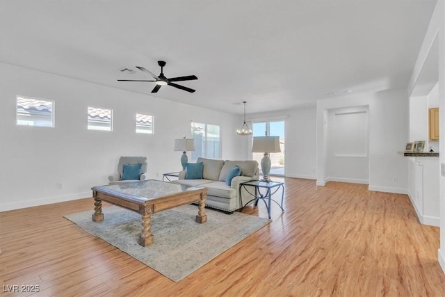 11253 Revelry Ln, Las Vegas, NV 89138 - living room featuring light wood-style flooring, ceiling fan, and a chandelier