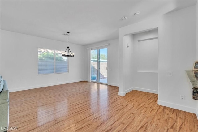 11253 Revelry Ln, Las Vegas, NV 89138 - empty room featuring a chandelier and light wood-style floors