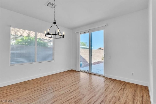 11253 Revelry Ln, Las Vegas, NV 89138 - unfurnished room featuring light wood-style floors and a chandelier