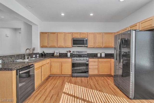 11253 Revelry Ln, Las Vegas, NV 89138 - kitchen featuring appliances with stainless steel finishes, light brown cabinets, light wood-style flooring, and recessed lighting