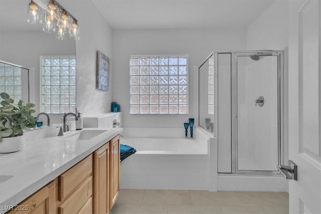 11253 Revelry Ln, Las Vegas, NV 89138 - bathroom with a shower stall, a bath, double vanity, and tile patterned floors