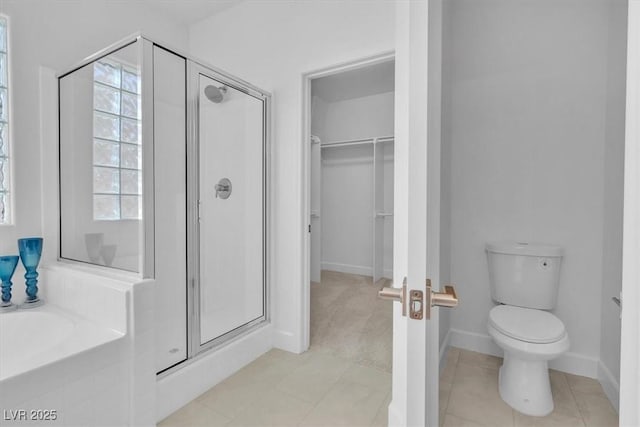 11253 Revelry Ln, Las Vegas, NV 89138 - full bathroom with a shower stall, a garden tub, a spacious closet, and tile patterned flooring