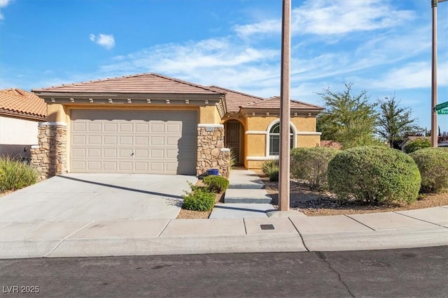 11253 Revelry Ln, Las Vegas, NV 89138 - view of front of home with stucco siding, driveway, a tile roof, a garage, and stone siding