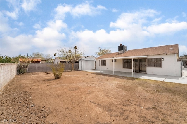 3309 Marionette Ave, Las Vegas, NV 89101 - back of property featuring a patio area, a fenced backyard, a storage unit, and a chimney