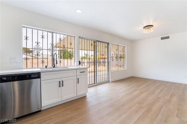 3309 Marionette Ave, Las Vegas, NV 89101 - kitchen with dishwasher, light countertops, light wood-style floors, white cabinets, and recessed lighting