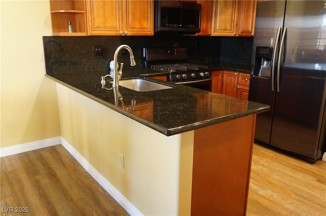 2851 S Valley View Blvd Unit 1134, Las Vegas, NV 89102 - kitchen featuring appliances with stainless steel finishes, dark stone countertops, light wood-type flooring, and tasteful backsplash