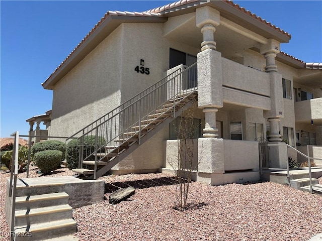 435 Mesa Blvd Unit 202, Mesquite, NV 89027 - view of home's exterior featuring stairs, a tile roof, and stucco siding