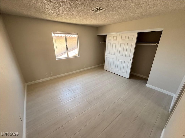 435 Mesa Blvd Unit 202, Mesquite, NV 89027 - unfurnished bedroom featuring a textured ceiling, light wood-style flooring, and a closet