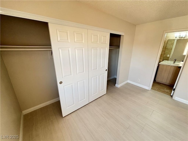 435 Mesa Blvd Unit 202, Mesquite, NV 89027 - unfurnished bedroom featuring a closet, a textured ceiling, and ensuite bath