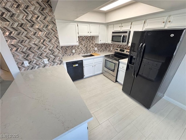 435 Mesa Blvd Unit 202, Mesquite, NV 89027 - kitchen featuring black appliances, backsplash, white cabinets, and light stone countertops