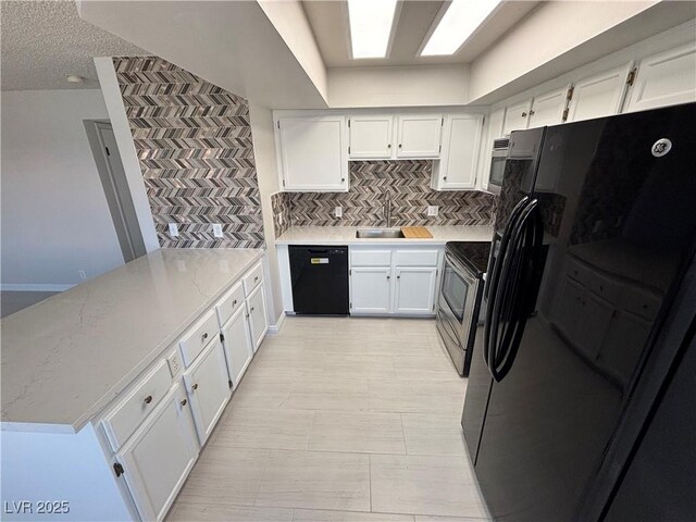 435 Mesa Blvd Unit 202, Mesquite, NV 89027 - kitchen with black appliances, a peninsula, decorative backsplash, light countertops, and white cabinets