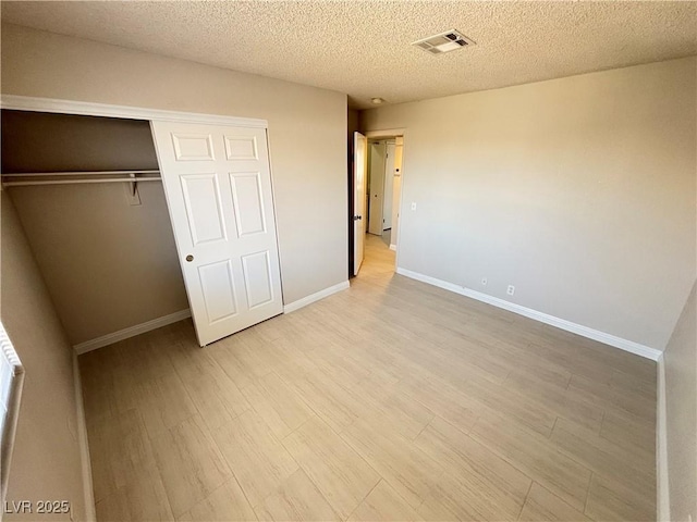 435 Mesa Blvd Unit 202, Mesquite, NV 89027 - unfurnished bedroom with light wood finished floors, a closet, and a textured ceiling