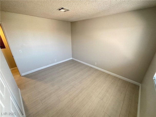 435 Mesa Blvd Unit 202, Mesquite, NV 89027 - spare room featuring light wood-style flooring and a textured ceiling