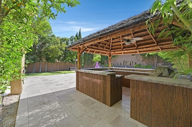 7033 Twin Forks Peak St, Las Vegas, NV 89166 - fenced backyard with a gazebo, a ceiling fan, a bar, and a patio
