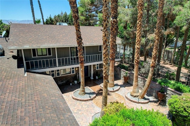 5260 N Jones Blvd, Las Vegas, NV 89130 - view of front of home with a shingled roof, a patio, and stone siding