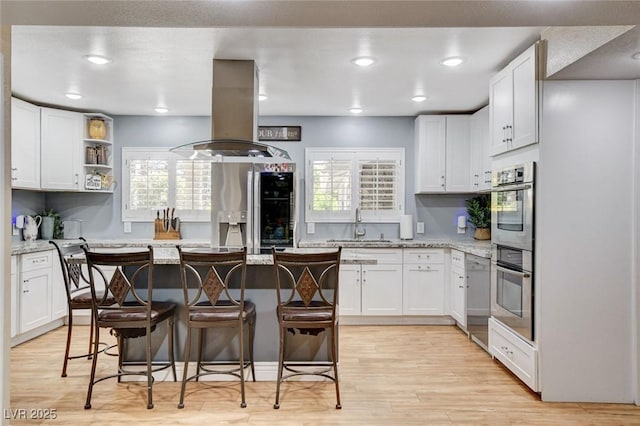 5260 N Jones Blvd, Las Vegas, NV 89130 - kitchen featuring stainless steel appliances, island exhaust hood, a kitchen breakfast bar, a center island, and recessed lighting
