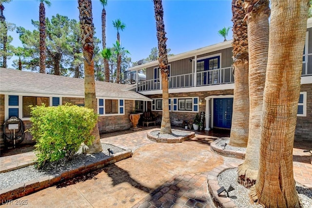 5260 N Jones Blvd, Las Vegas, NV 89130 - rear view of property featuring a balcony, stone siding, and french doors
