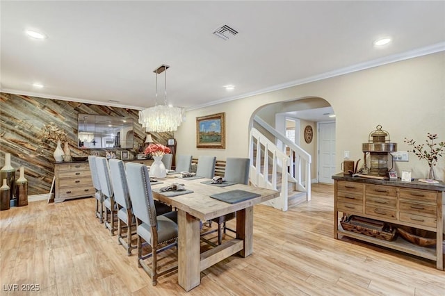 5260 N Jones Blvd, Las Vegas, NV 89130 - dining area with arched walkways, light wood finished floors, stairs, crown molding, and recessed lighting