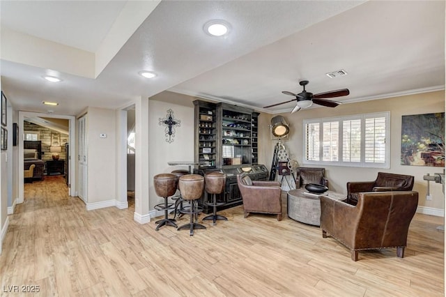 5260 N Jones Blvd, Las Vegas, NV 89130 - living room featuring light wood-style flooring, ceiling fan, recessed lighting, a dry bar, and crown molding