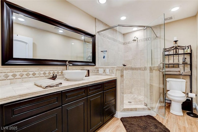 5260 N Jones Blvd, Las Vegas, NV 89130 - bathroom with a shower stall, vanity, tasteful backsplash, wood finished floors, and recessed lighting