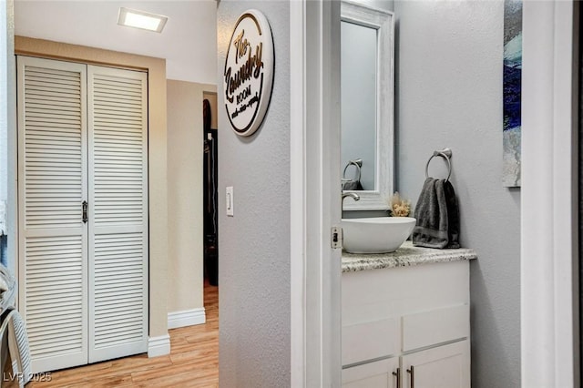 5260 N Jones Blvd, Las Vegas, NV 89130 - bathroom with vanity, wood finished floors, a closet, and a textured wall