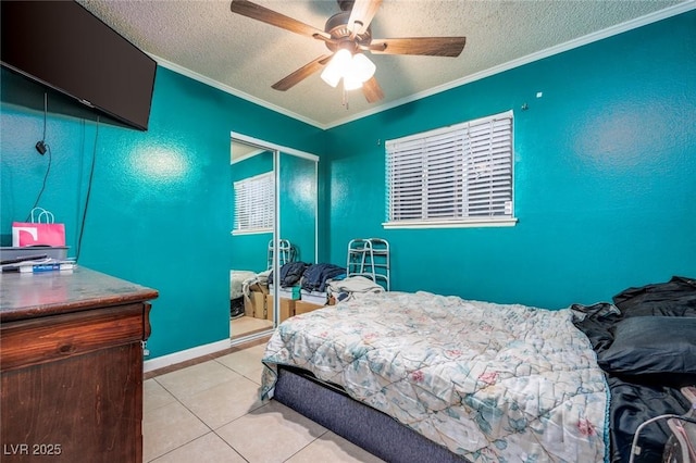 224 Catalini St, Las Vegas, NV 89107 - bedroom with a textured ceiling, crown molding, light tile patterned floors, ceiling fan, and a closet