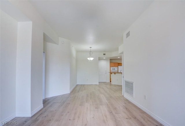 23 E Agate Ave Unit 207, Las Vegas, NV 89123 - unfurnished living room with light wood-style floors