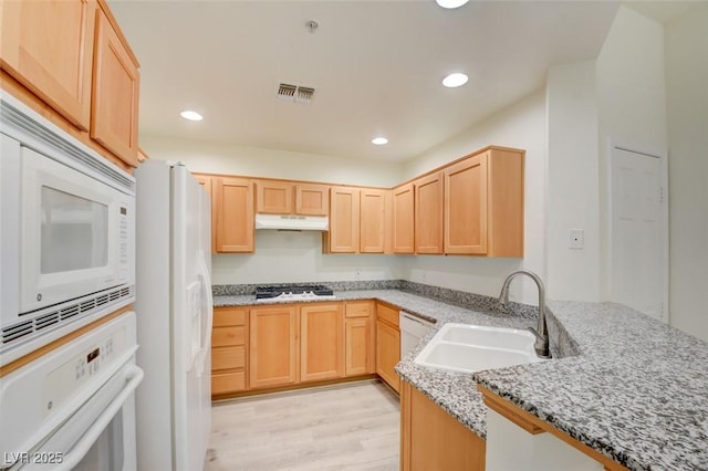 23 E Agate Ave Unit 207, Las Vegas, NV 89123 - kitchen with light brown cabinetry, white appliances, under cabinet range hood, light stone counters, and recessed lighting