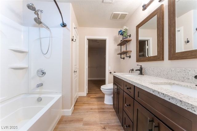 455 Westminster Hall Ave Unit 101, North Las Vegas, NV 89032 - bathroom featuring double vanity, wood finished floors, shower / washtub combination, and a closet