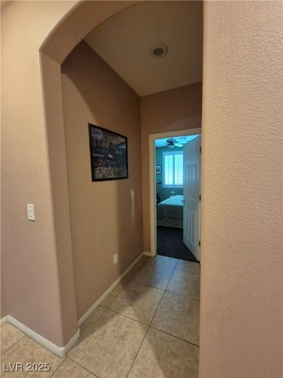 6009 Arbor Crest St, North Las Vegas, NV 89081 - corridor featuring light tile patterned flooring and arched walkways