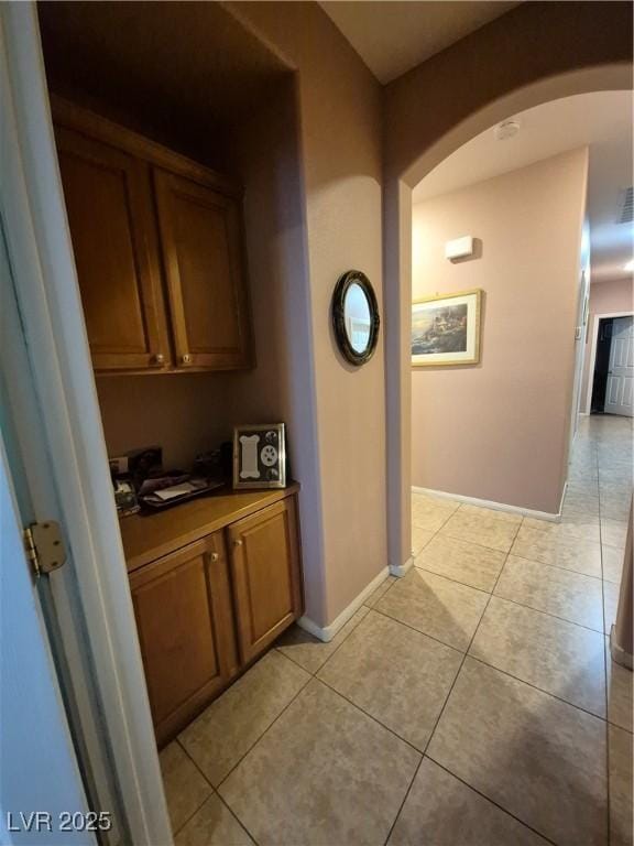 6009 Arbor Crest St, North Las Vegas, NV 89081 - hallway featuring arched walkways and light tile patterned floors
