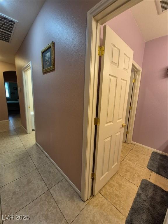 6009 Arbor Crest St, North Las Vegas, NV 89081 - corridor featuring light tile patterned floors and baseboards