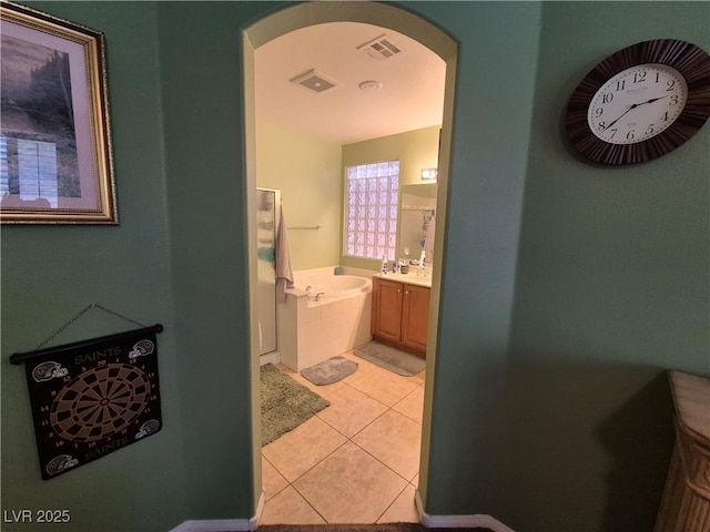 6009 Arbor Crest St, North Las Vegas, NV 89081 - bathroom featuring a garden tub, tile patterned floors, and vanity