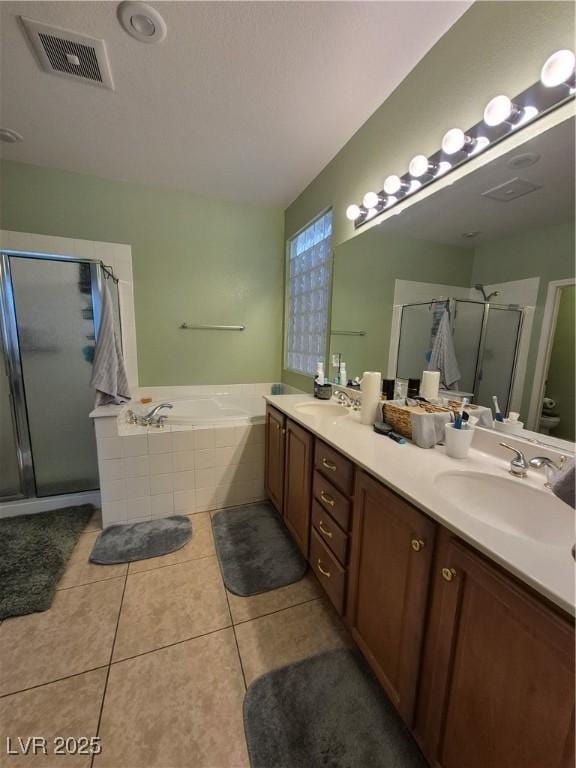 6009 Arbor Crest St, North Las Vegas, NV 89081 - full bathroom featuring a stall shower, double vanity, a bath, and tile patterned flooring
