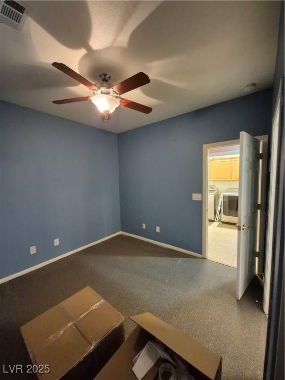 6009 Arbor Crest St, North Las Vegas, NV 89081 - carpeted spare room featuring washer and dryer, ceiling fan, and a smoke detector