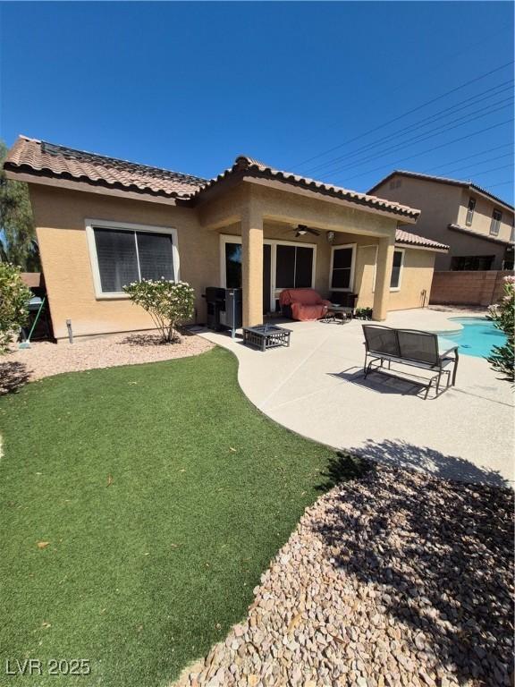 6009 Arbor Crest St, North Las Vegas, NV 89081 - rear view of house with a patio, ceiling fan, stucco siding, and a tile roof