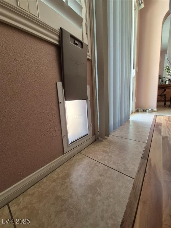 6009 Arbor Crest St, North Las Vegas, NV 89081 - hallway featuring arched walkways and a textured wall