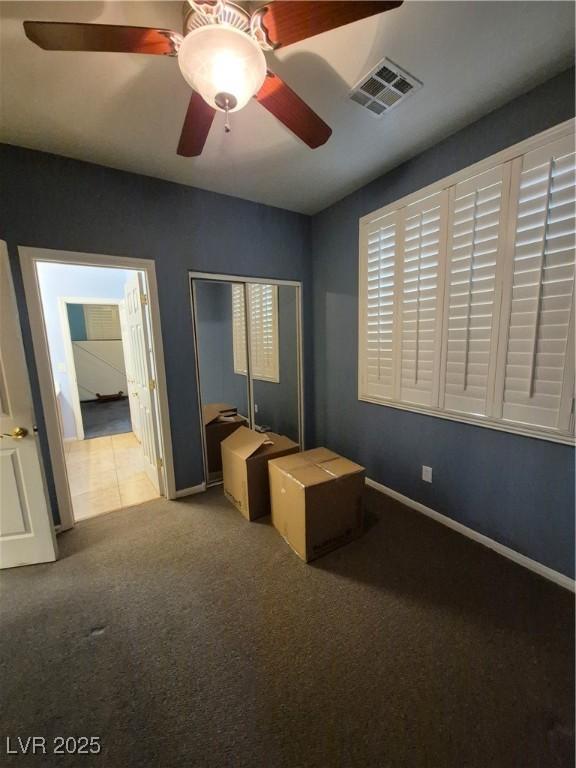 6009 Arbor Crest St, North Las Vegas, NV 89081 - unfurnished bedroom featuring carpet, a closet, and a ceiling fan