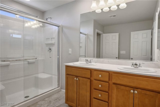9136 Cocowoods Pl, Las Vegas, NV 89148 - bathroom featuring a stall shower, double vanity, and tile patterned flooring