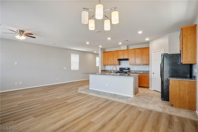 9136 Cocowoods Pl, Las Vegas, NV 89148 - kitchen featuring range, open floor plan, freestanding refrigerator, light wood finished floors, and recessed lighting
