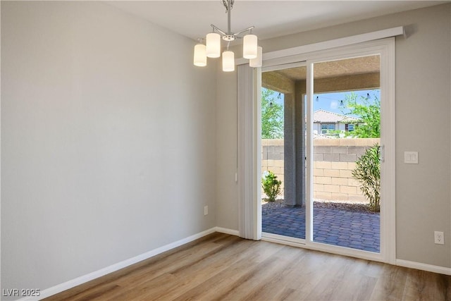 9136 Cocowoods Pl, Las Vegas, NV 89148 - empty room featuring wood finished floors and a chandelier