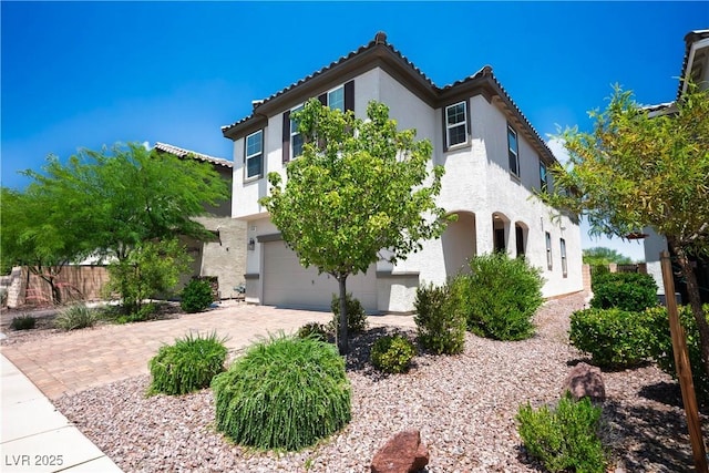 9136 Cocowoods Pl, Las Vegas, NV 89148 - view of front of home featuring an attached garage, stucco siding, a tiled roof, and driveway