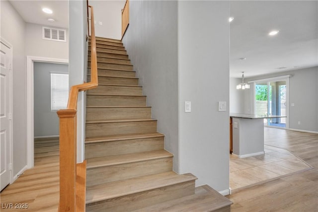 9136 Cocowoods Pl, Las Vegas, NV 89148 - stairs with wood finished floors, recessed lighting, and a chandelier