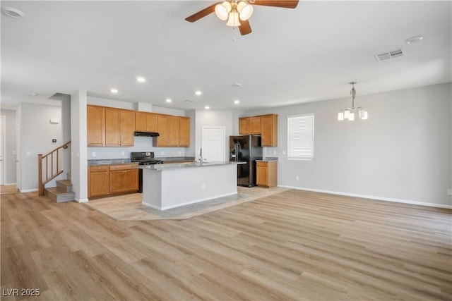 9136 Cocowoods Pl, Las Vegas, NV 89148 - kitchen featuring black appliances, a chandelier, ceiling fan, open floor plan, and light wood finished floors