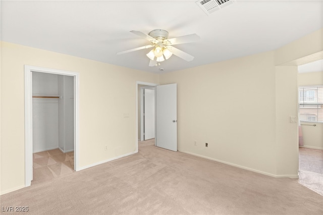 10437 Coyote Cub Ave, Las Vegas, NV 89129 - unfurnished bedroom featuring light carpet, a walk in closet, a ceiling fan, and a closet