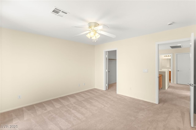 10437 Coyote Cub Ave, Las Vegas, NV 89129 - unfurnished bedroom featuring light colored carpet, a spacious closet, ceiling fan, and a closet