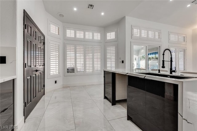 825 Royal Moon Ave, Las Vegas, NV 89123 - kitchen featuring light countertops, recessed lighting, light marble finish floors, and a center island with sink