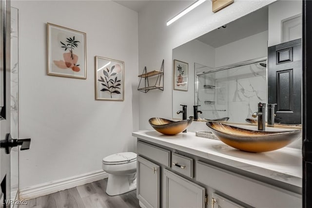 825 Royal Moon Ave, Las Vegas, NV 89123 - bathroom featuring a marble finish shower, double vanity, and wood finished floors