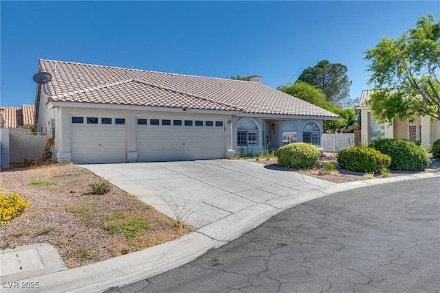 825 Royal Moon Ave, Las Vegas, NV 89123 - mediterranean / spanish home with a garage, driveway, a tiled roof, and stucco siding